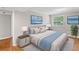 Comfortable bedroom features neutral walls, hardwood floors, and beach themed decor at 2358 Dabney Ter, East Point, GA 30344