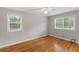 Empty bedroom with hardwood floors and two windows has plenty of sunlight at 2358 Dabney Ter, East Point, GA 30344