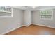 Bright bedroom featuring wood-look flooring and two windows providing ample natural light at 2358 Dabney Ter, East Point, GA 30344
