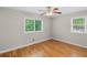 Empty bedroom with hardwood floors and two windows brings in plenty of natural light at 2358 Dabney Ter, East Point, GA 30344