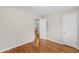 Bedroom with hardwood floors has an attached closet and leads to another room at 2358 Dabney Ter, East Point, GA 30344