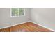 Empty bedroom features hardwood floors and a window with lovely outdoor views at 2358 Dabney Ter, East Point, GA 30344