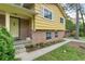 Charming home with a yellow exterior, brick foundation and well-maintained landscaping at 2358 Dabney Ter, East Point, GA 30344