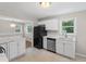 Updated kitchen with new white cabinets, stainless steel appliances and marble countertops at 2358 Dabney Ter, East Point, GA 30344