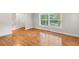 Bright living room with beautiful hardwood floors and large windows overlooking the yard at 2358 Dabney Ter, East Point, GA 30344