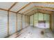 The interior of the shed featuring metal walls, wood beams and cement flooring at 2358 Dabney Ter, East Point, GA 30344