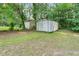 View of the two storage sheds in the backyard with grass and trees at 2358 Dabney Ter, East Point, GA 30344