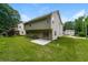 Backyard view of the home with a well-maintained lawn and mature trees at 4400 Old Allgood Cir, Stone Mountain, GA 30083
