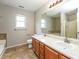 Bathroom showcasing double sinks, a large mirror, and a shower with glass door at 4400 Old Allgood Cir, Stone Mountain, GA 30083