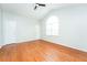 Bright bedroom features a vaulted ceiling, a large window, and hardwood flooring at 4400 Old Allgood Cir, Stone Mountain, GA 30083
