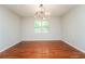 Empty bedroom with hardwood floors, natural light, neutral walls, and modern lighting at 4400 Old Allgood Cir, Stone Mountain, GA 30083