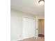 Bedroom featuring a closet with bifold doors and access to the hallway at 4400 Old Allgood Cir, Stone Mountain, GA 30083