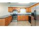 Well-lit kitchen featuring stainless steel appliances, wood cabinets and neutral flooring at 4400 Old Allgood Cir, Stone Mountain, GA 30083