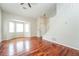 Living room with gleaming hardwood floors, bay window, vaulted ceilings, and an open staircase at 4400 Old Allgood Cir, Stone Mountain, GA 30083