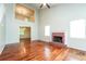 Spacious living room with hardwood floors, fireplace, abundant natural light and an open staircase at 4400 Old Allgood Cir, Stone Mountain, GA 30083