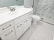 Updated bathroom featuring a white vanity, sink, toilet, and tiled walk-in shower at 5025 Highland Club Dr, Marietta, GA 30068