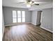 Bright bedroom features new wood flooring, ceiling fan, and neutral paint throughout at 5025 Highland Club Dr, Marietta, GA 30068