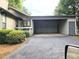 Exterior of home showing attached carport, siding, and manicured green bushes at 5025 Highland Club Dr, Marietta, GA 30068