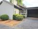 Side view of home exterior featuring an attached carport, neutral paint, and green foliage at 5025 Highland Club Dr, Marietta, GA 30068
