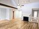 Spacious living room boasts hardwood floors, a ceiling fan, fireplace, and staircase at 5025 Highland Club Dr, Marietta, GA 30068