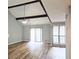 Bright living room features beamed ceilings, ceiling fan, wood floors, and sliding doors to the outside at 5025 Highland Club Dr, Marietta, GA 30068
