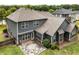 Aerial view of the backyard featuring stone patio, mature trees and lush landscaping at 1045 Fords Crossing Nw Dr, Acworth, GA 30101