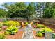 Secluded backyard fire pit area with stone path and Adirondack chairs, perfect for outdoor relaxation at 1045 Fords Crossing Nw Dr, Acworth, GA 30101