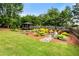 Well-manicured backyard featuring a gazebo, fire pit, and manicured landscaping at 1045 Fords Crossing Nw Dr, Acworth, GA 30101