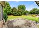 Charming backyard with stone patio, lush greenery, and a gazebo at 1045 Fords Crossing Nw Dr, Acworth, GA 30101