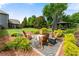 Beautiful outdoor living space featuring a fire pit, seating, and gazebo in a well-manicured backyard at 1045 Fords Crossing Nw Dr, Acworth, GA 30101