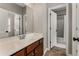 Well-lit bathroom with vanity, mirror, and tile flooring, complemented by a separate door to a shower area at 1045 Fords Crossing Nw Dr, Acworth, GA 30101