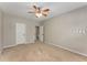 Neutral bedroom featuring a ceiling fan and a door to the hallway at 1045 Fords Crossing Nw Dr, Acworth, GA 30101