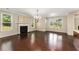 Bright dining room with a fireplace, chandelier, and large windows overlooking the yard at 1045 Fords Crossing Nw Dr, Acworth, GA 30101