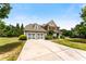 Charming two-story home featuring a brick facade, attached two-car garage, and meticulously landscaped front yard at 1045 Fords Crossing Nw Dr, Acworth, GA 30101