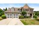 Charming two-story brick home with a manicured lawn and two-car garage at 1045 Fords Crossing Nw Dr, Acworth, GA 30101