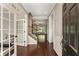 Inviting home foyer with hardwood floors, white wainscoting, and a staircase at 1045 Fords Crossing Nw Dr, Acworth, GA 30101