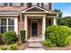 Elegant front door with white pillars and manicured bushes leading to a beautiful brick facade at 1045 Fords Crossing Nw Dr, Acworth, GA 30101