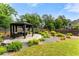 Stone-paved gazebo featuring outdoor seating in a landscaped backyard, creating a serene retreat at 1045 Fords Crossing Nw Dr, Acworth, GA 30101