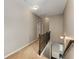 Upper-level hallway with carpet flooring, wood railing, and sconce lighting, creating a warm and inviting atmosphere at 1045 Fords Crossing Nw Dr, Acworth, GA 30101