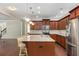 Beautiful kitchen with dark wood cabinets, granite countertops, stainless steel appliances, and a center island at 1045 Fords Crossing Nw Dr, Acworth, GA 30101