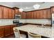 Kitchen featuring wood cabinets, stainless steel appliances, and granite countertops at 1045 Fords Crossing Nw Dr, Acworth, GA 30101