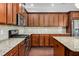 A kitchen featuring wooden cabinets, stainless steel appliances, and a granite countertop at 1045 Fords Crossing Nw Dr, Acworth, GA 30101