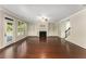 Open-concept living room featuring hardwood floors, built-in shelving, and a fireplace at 1045 Fords Crossing Nw Dr, Acworth, GA 30101
