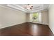 A bright main bedroom features a tray ceiling and hardwood floors at 1045 Fords Crossing Nw Dr, Acworth, GA 30101