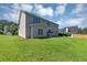 Backyard featuring a large grassy area and exterior of a two-story house at 1685 Great Oaks Dr, Lawrenceville, GA 30045