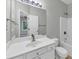 Well-lit bathroom featuring a large mirror, white vanity, and a shower-tub combination at 1685 Great Oaks Dr, Lawrenceville, GA 30045
