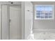 This bathroom has a shower, a bathtub with jets, and a window for natural light at 1685 Great Oaks Dr, Lawrenceville, GA 30045