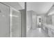 Bright bathroom featuring a tiled floor, glass shower, soaking tub, and double sink vanity at 1685 Great Oaks Dr, Lawrenceville, GA 30045