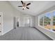 Bright bedroom with vaulted ceiling, ceiling fan, big window, and gray carpet at 1685 Great Oaks Dr, Lawrenceville, GA 30045