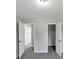 Spacious bedroom with neutral walls, gray carpet, and two white doors at 1685 Great Oaks Dr, Lawrenceville, GA 30045